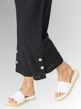 Meet your new wardrobe foundation. The Essential Button Pant in black is meticulously crafted for the modern woman who refuses to sacrifice comfort for style. Whether you are running weekend errands or dressing up for a casual evening out, these pants deliver a beautifully polished look. Designed with a relaxed, wide-leg silhouette and a chic cropped length, this piece offers a breezy, fashion-forward cut that moves beautifully with you.