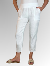 Elevate your warm-weather wardrobe with the Ankle Tuck Linen Resort Pant in White, the ultimate choice for effortless summer style. Perfectly balancing a trendy silhouette with everyday practicality, these pants are crafted from premium, breathable linen designed to keep you cool and comfortable all day long.