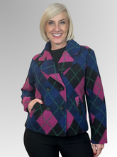 Make a statement in our Argyle Double-Breasted Jacket. Showcasing a bold argyle design in black, pink, navy, and green, this standout piece brings a modern twist to a timeless silhouette. Crafted from a premium wool blend, it offers both warmth and comfort without compromising on style. Designed with a classic collar, functional pockets, and a flattering slightly cropped length, this versatile jacket moves effortlessly from weekday wear to relaxed weekend styling. Pair it with tailored trousers for a refine