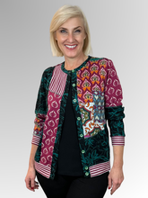 The Prato Cardi Top by Orientique is a fun and modern addition to any wardrobe. Its spliced design offers versatility, allowing you to wear it open with a plain top underneath or buttoned up for a more polished look. Made with a black base colour and crafted from cotton this top is both comfortable and stylish. A must-have for any fashion-forward individual!