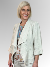 The Natural Peplum Jacket by Maglia is your perfect summer companion. Made from breathable linen, it features a stylish waterfall collar and a layered peplum for shape. With charming raw edging and fold-back 3/4-length sleeves, this versatile piece transitions effortlessly from workdays to weekend adventures. Light, playful, and effortlessly chic!