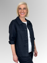 Meet the Button-Through Linen Resort Jacket in Navy, your new go-to layer for effortless, everyday style. Crafted from 100% pure linen, this lightweight jacket combines a relaxed, breezy silhouette with tailored details. It features a classic shirt collar and a full button-down front, making it easy to wear open over a tank or closed as a structured shirt. Designed for ultimate versatility, the sleeves come with built-in tab-and-button cuffs so you can easily roll them up on warmer days. 