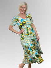 Introducing the Amalfi Godet Dress by Orientique! Made from soft, sustainable rayon, this dress features a hand painted Italian Riviera print in a gorgeous array of colours. The crinkle fabric is oh-so-comfy with no ironing required. Featuring short sleeves, a flattering V-neckline and godet panels through the skirt that create a beautiful drape and swing.&nbsp;Perfect for summer, this cool and flowy dress is a must-have addition to your wardrobe.