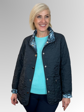 Elevate your seasonal wardrobe with the Reversible Sienna Jacket in Navy, a sophisticated two-in-one piece that adapts to your style. Crafted from easy-care nylon and polyester, this lightweight jacket features elegant embroidered detailing, practical press stud closure, and convenient pockets. Wear it one way for a polished look, then flip it for an entirely different aesthetic. Perfect for autumn and winter layering, it's the versatile essential that delivers double the style.