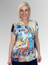 Transport your wardrobe to the sun-drenched Mediterranean with the Santorini Cap Sleeve Top by Equinox Clothing. Featuring a vibrant, picturesque print inspired by the iconic blue domes, stone paths, and blooming bougainvillea of Greece, this top brings an instant resort-wear feel to your everyday style.