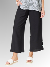 Meet your new wardrobe foundation. The Essential Button Pant in black is meticulously crafted for the modern woman who refuses to sacrifice comfort for style. Whether you are running weekend errands or dressing up for a casual evening out, these pants deliver a beautifully polished look. Designed with a relaxed, wide-leg silhouette and a chic cropped length, this piece offers a breezy, fashion-forward cut that moves beautifully with you.