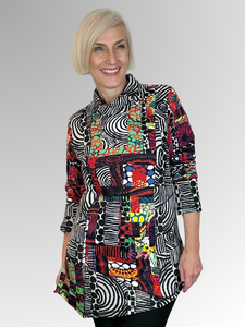 The Runaway Train Roll Neck Tunic by Orientique is a versatile addition to any wardrobe. Crafted from a cozy blend of rayon and spandex, this tunic boasts an asymmetric patchwork shape, blending textures and fabrics with a playful vibrant design. The relaxed roll neck and elongated silhouette offer a comfy and flattering fit that's effortlessly chic.