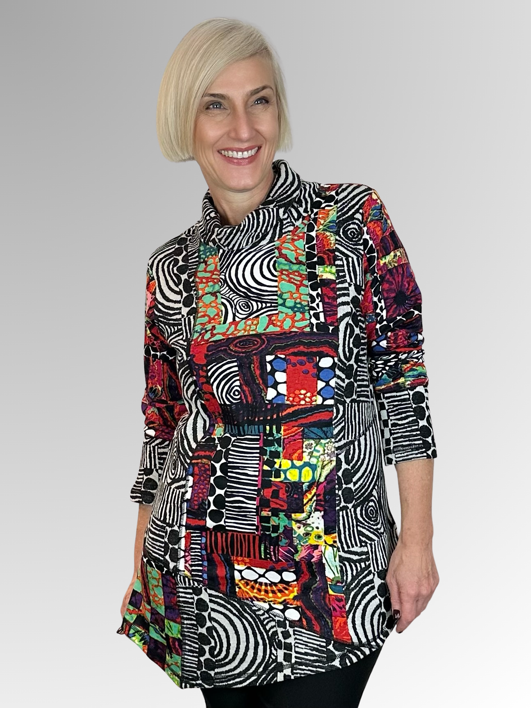 The Runaway Train Roll Neck Tunic by Orientique is a versatile addition to any wardrobe. Crafted from a cozy blend of rayon and spandex, this tunic boasts an asymmetric patchwork shape, blending textures and fabrics with a playful vibrant design. The relaxed roll neck and elongated silhouette offer a comfy and flattering fit that's effortlessly chic.