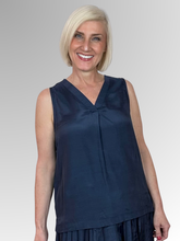 Elevate your core wardrobe with the effortlessly chic Navy Lux Sleeveless Top by Escape. This sophisticated staple offers a beautifully polished look with its subtle satin-like sheen, making it easy to dress up or down. Crafted from premium, breathable rayon, it feels incredibly light and smooth against the skin, delivering a fluid drape that moves gracefully with you.