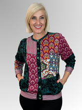 The Prato Cardi Top by Orientique is a fun and modern addition to any wardrobe. Its spliced design offers versatility, allowing you to wear it open with a plain top underneath or buttoned up for a more polished look. Made with a black base colour and crafted from cotton this top is both comfortable and stylish. A must-have for any fashion-forward individual!