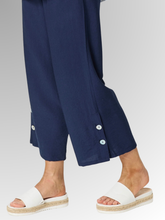 Meet your new wardrobe foundation. The Essential Button Pant in classic navy is meticulously crafted for the modern woman who refuses to sacrifice comfort for style. Whether you are running weekend errands or dressing up for a casual evening out, these pants deliver a beautifully polished look. Designed with a relaxed, wide-leg silhouette and a chic cropped length, this piece offers a breezy, fashion-forward cut that moves beautifully with you.