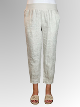Elevate your warm-weather wardrobe with the Ankle Tuck Linen Resort Pant in Natural, the ultimate choice for effortless summer style. Perfectly balancing a trendy silhouette with everyday practicality, these pants are crafted from premium, breathable linen designed to keep you cool and comfortable all day long.