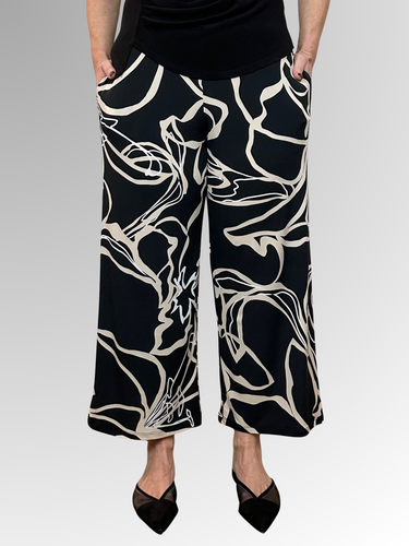 Bring a fresh and playful vibe to your wardrobe with the Lotus 7/8 Pant by Philosophy. Showcasing a chic black, beige and white print, these wide-leg pants offer a modern silhouette that’s effortlessly stylish. The elastic waist ensures comfort, while handy pockets add practicality. Perfectly cropped at 7/8 length, they’re made from easy-care polyester elastane for a smooth fit and simple maintenance.