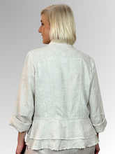 The Natural Peplum Jacket by Maglia is your perfect summer companion. Made from breathable linen, it features a stylish waterfall collar and a layered peplum for shape. With charming raw edging and fold-back 3/4-length sleeves, this versatile piece transitions effortlessly from workdays to weekend adventures. Light, playful, and effortlessly chic!