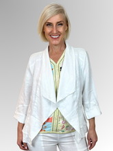 The White Peplum Jacket by Maglia is your perfect summer companion. Made from breathable linen, it features a stylish waterfall collar and a layered peplum for shape. With charming raw edging and fold-back 3/4-length sleeves, this versatile piece transitions effortlessly from workdays to weekend adventures. Light, playful, and effortlessly chic!