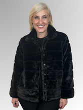 Wrap yourself in effortless sophistication with the beautifully crafted Gigi Faux Fur Jacket. Made from soft, high-quality polyester, it delivers the plush look and feel of real fur while remaining lightweight and easy to wear. In classic black, it offers timeless appeal - sleek, versatile, and endlessly easy to style.&nbsp;Featuring a structured collar and a flattering cropped silhouette, this jacket blends elegance with a modern edge. The horizontal panel detailing adds subtle texture and depth, while the