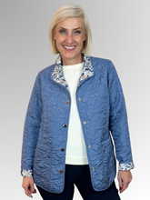 Elevate your seasonal wardrobe with the Reversible Sienna Jacket in Wedgewood, a sophisticated two-in-one piece that adapts to your style. Crafted from easy-care nylon and polyester, this lightweight jacket features elegant embroidered detailing, practical press stud closure, and convenient pockets. Wear it one way for a polished look, then flip it for an entirely different aesthetic. Perfect for autumn and winter layering, it's the versatile essential that delivers double the style.