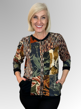 The Dagomba Cardi Top by Orientique is a fun and modern addition to any wardrobe. Its spliced design offers versatility, allowing you to wear it open with a plain top underneath or buttoned up for a more polished look. Made with a black base colour and crafted from rayon and spandex, this top is both comfortable and stylish. A must-have for any fashion-forward individual!