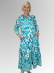 Look chic and feel comfortable this summer in the Orientique Izmir Turquoise Shirt Dress! Made from 100% organic crinkled cotton, this light and cool dress features 3/4 length sleeves, a collar, and a button-through closure. Whether lounging at home or out for a day on the town, this dress is the perfect way to look stylish and stay cool.