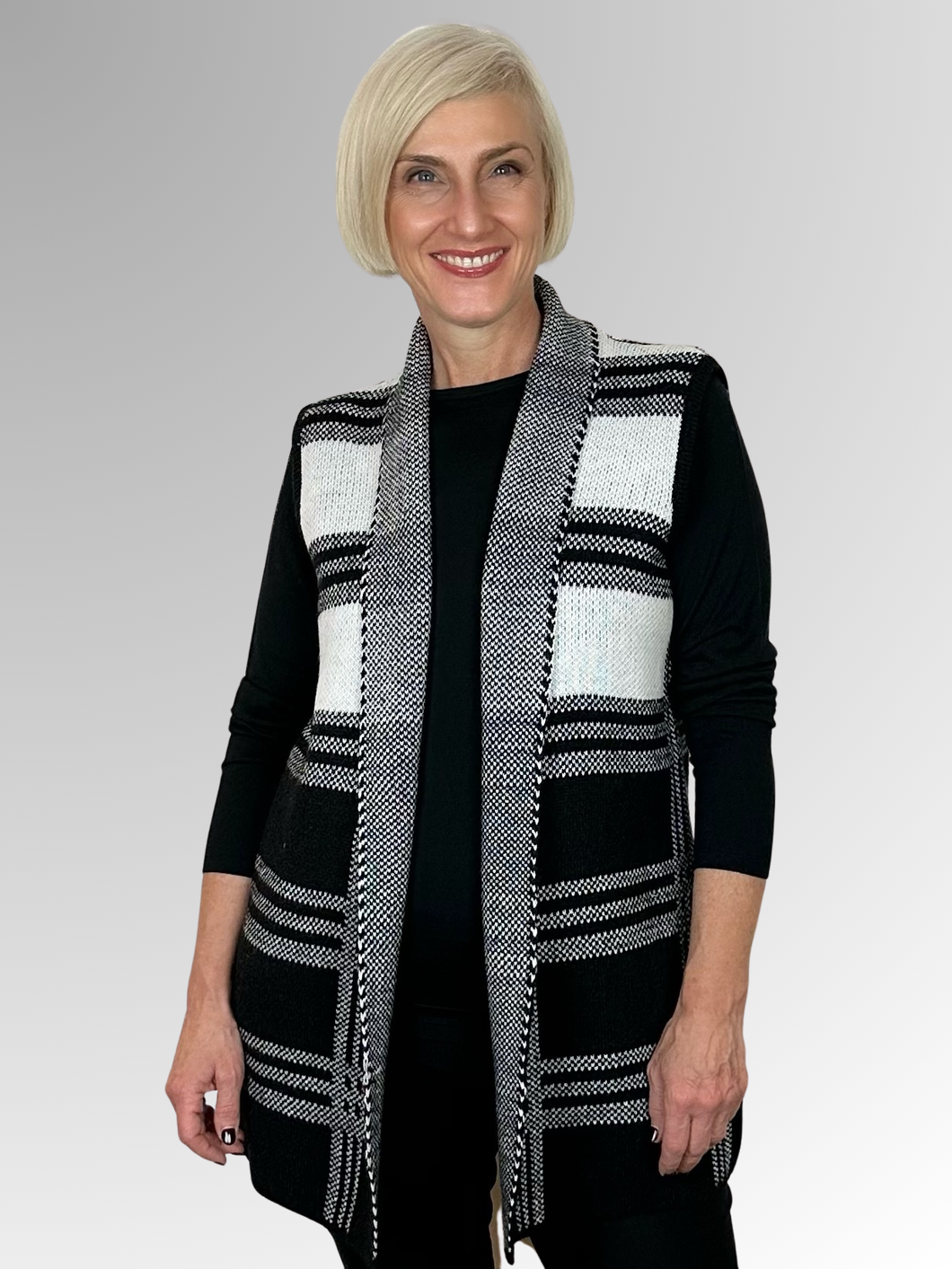 Get ready to make a statement in our Black and White Geometric Knit Vest by Jillian! This striking piece is not only versatile, but also perfect for layering. Made from a blend of acrylic, nylon, and polyester, its longline design will keep you both stylish and warm. Elevate your wardrobe with this must-have piece!