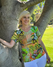 Transport yourself to exotic destinations with every wear in the charming Giorgia V-Neck Tee from Escape by Orientique. Adorned with eye-catching prints that spark adventure, this laid-back essential delivers comfort without compromise. The flattering V-neckline and breezy short sleeves create an effortlessly chic silhouette, while the relaxed fit ensures you can move freely whether you're exploring new horizons or dreaming of them. Crafted from a breathable cotton, rayon, and spandex blend that feels as go