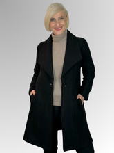 Wrap yourself in luxury with our Boiled Wool Black Pea Coat. Certified with the prestigious Woolmark label, this modern, soft boiled wool coat is both warm and stylish. Featuring a contemporary take on the classic coat, it's the perfect statement piece for any fashion-forward wardrobe. Upgrade your look and embrace true quality.