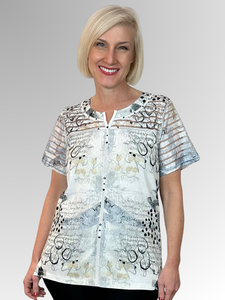 Enhance your wardrobe with the Bagoraz Calista Top, expertly crafted in Portugal for women who appreciate rich textures, intricate details, and exceptional comfort. Made from a high-quality cotton and polyester blend, this elegant top features delicate burnout accents on the upper body and sleeves, complemented by refined stitch and stud embellishments along the neckline and front, creating a polished and sophisticated look. Let Bagoraz bring a subtle yet striking flair to your style.