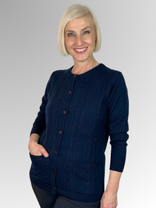 For over 70 years, Slade Knitwear has been an iconic Australian brand known for its high-quality women's knitwear. This classic Navy Cable Front Cardigan, made from 100% Pure New Wool and featuring two pockets, is a must-have for winter. Trust Slade for all your knitwear needs.