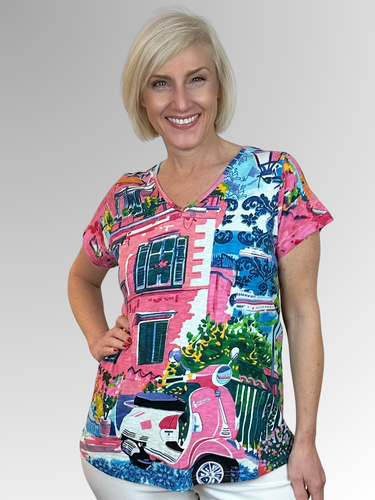 Step into summer effortlessly with this relaxed, easy-to-wear tee! Orientique is known for striking colours and stylish designs that feel fresh and modern. The Scooter V-Neck Tee, created by Orientique’s artists, is made from Certified Organic Cotton and showcases a colourful European streetscape print. Its A-line shape gently drapes over the tummy and hips, offering a roomy, comfortable fit perfect for sunny days.