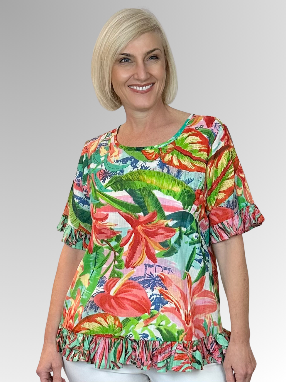 Made from soft organic cotton, the Equador Frill Top by Orientique features a relaxed A-line shape and generous fit for ultimate summer comfort. Playful frills adorn the hem and sleeves with a button-down back for an interesting twist. Exotic florals in a beautiful mix of coral, tangerine, and green bring vibrant, artistic flair to sunny days and warm evenings. This top is your go-to for effortless, breezy style all summer long.