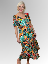 Introducing the Guaratiba Godet Dress by Orientique! Made from soft, sustainable rayon, this dress features a hand painted tropical print in orange, teals and black. The crinkle fabric is oh-so-comfy with no ironing required. Featuring short sleeves, a flattering V-neckline and godet panels through the skirt that create a beautiful drape and swing.&nbsp;Perfect for summer, this cool and flowy dress is a must-have addition to your wardrobe.