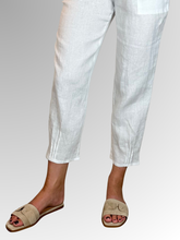 Elevate your warm-weather wardrobe with the Ankle Tuck Linen Resort Pant in White, the ultimate choice for effortless summer style. Perfectly balancing a trendy silhouette with everyday practicality, these pants are crafted from premium, breathable linen designed to keep you cool and comfortable all day long.