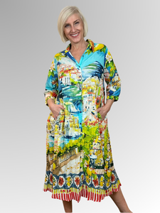 Step into summer with flair and comfort in the Amalfi Button Through Collared Dress by Orientique! This breezy dress, made from soft organic crinkled cotton, showcases a delightful Italian Riviera print, 3/4 sleeves, a crisp collar, and a button-through front. Whether you're relaxing at home or exploring the town, the Amalfi adds a splash of fun and effortless style to your day.