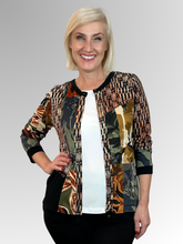 The Dagomba Cardi Top by Orientique is a fun and modern addition to any wardrobe. Its spliced design offers versatility, allowing you to wear it open with a plain top underneath or buttoned up for a more polished look. Made with a black base colour and crafted from rayon and spandex, this top is both comfortable and stylish. A must-have for any fashion-forward individual!