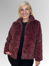 Wrap yourself in effortless sophistication with the beautifully crafted Gigi Faux Fur Jacket. Made from soft, high-quality polyester, it delivers the plush look and feel of real fur while remaining lightweight and easy to wear.&nbsp;The rich, warm-toned claret hue adds depth and sophistication, making it a standout piece for cooler days and evenings.&nbsp;Designed with a structured collar and a flattering cropped silhouette, this jacket combines elegance with modern style. The horizontal panel detailing cre