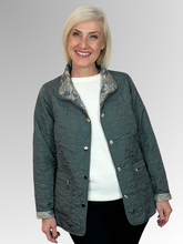 Elevate your seasonal wardrobe with the Reversible Sienna Jacket in Sage, a sophisticated two-in-one piece that adapts to your style. Crafted from easy-care nylon and polyester, this lightweight jacket features elegant embroidered detailing, practical press stud closure, and convenient pockets. Wear it one way for a polished look, then flip it for an entirely different aesthetic. Perfect for autumn and winter layering, it's the versatile essential that delivers double the style.