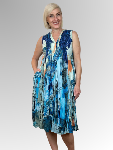 Slip into summer style with the Tower Blue Sleeveless Pleat Dress by Orientique. This breathable crinkled organic cotton piece features a captivating print and flattering V-neckline with subtle pleating at the bust. Convenient pockets add everyday practicality to this lightweight essential. Comfortable, stylish, and wonderfully relaxed, it's the dress you'll reach for whenever warm weather calls.