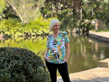 Embrace sunny days in the Aegean Tee by Jillian, featuring a vibrant tropical print that brings fun to your wardrobe. The relaxed fit and flattering V-neck offer effortless style, while the soft polyester-elastane blend ensures comfort all day long. Perfect for a carefree, summery vibe that turns heads wherever you go.