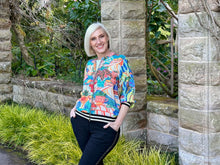 Bring playful style to your wardrobe with Orientique’s Picnic Digital Print Zip Jacket. Crafted from lightweight rayon with a luxurious satin finish, it offers effortless comfort in a relaxed bomber silhouette. The striking digital print is perfectly elevated by eye-catching black and gold lurex bands at the cuffs and hem. Complete with a breezy zip front, it is the perfect fashion-forward layer to easily elevate any everyday outfit.