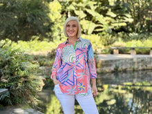 Bring a gentle splash of colour and personality to your seasonal wardrobe. The Urban Jungle Print Overshirt is a statement piece designed to instantly elevate your everyday style. Featuring a muted tropical print in a subtle palette of soft pink, green, coral, and blue tones, this shirt combines beautiful visual texture with a relaxed aesthetic that feels perfect for the season.
