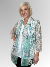 Our fashionable Wispy Twofer Top offers a stylish summer look. Crafted to flatter the figure while seamlessly concealing tummies and hips, this piece features a sewn-in camisole and free-flowing jacket. Featuring a feminine print in soft blue and pewter tones, it's made of polyester, chiffon and mesh for added sophistication. Easily washable and drip-drying, this top requires no ironing.