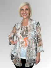 Our fashionable Breezy Twofer Top offers a stylish summer look. Crafted to flatter the figure while seamlessly concealing tummies and hips, this piece features a sewn-in camisole and free-flowing jacket. Featuring a feminine print in earthy tones, it's made of polyester, chiffon and mesh for added sophistication. Easily washable and drip-drying, this top requires no ironing.