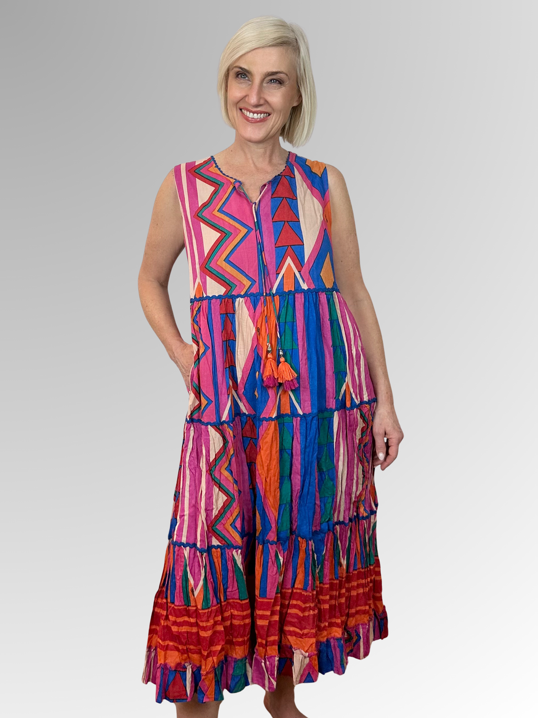 The Jacuma Sleeveless Tassel Dress is your ticket to carefree summer fun. This lightweight midi features a relaxed silhouette, tasseled ties, a finely ruffled hem and a sleeveless design that keeps you cool and comfy all day long. Made from a blend of cotton and rayon, it's the perfect companion for beach getaways, seaside strolls, and those golden-hour moments. Slip it on and embrace effortless style with a playful twist.