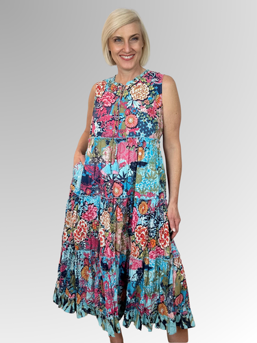 The Ikebana Sleeveless Tassel Dress is your ticket to carefree summer fun. This lightweight midi features a relaxed silhouette, tasseled ties, a finely ruffled hem and a sleeveless design that keeps you cool and comfy all day long. Made from 100% organic cotton, it's the perfect companion for beach getaways, seaside strolls, and those golden-hour moments. Slip it on and embrace effortless style with a playful twist.