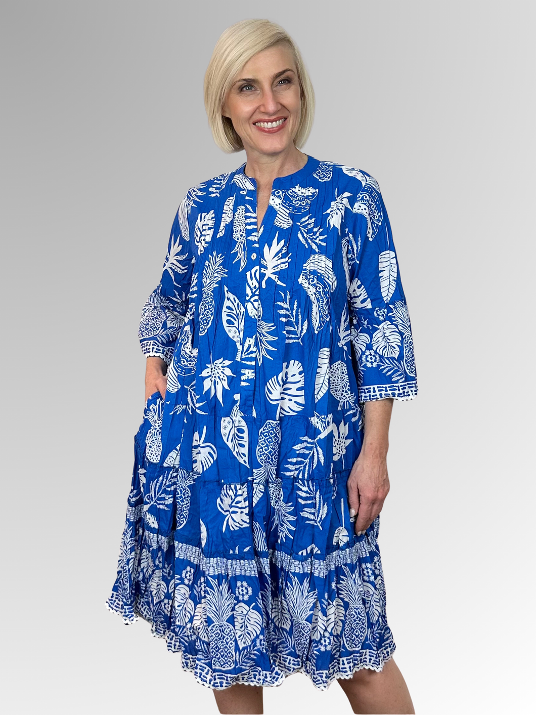 Discover effortless summer style with the Comodoro Blue 3/4 Sleeve Frill Dress by Orientique. This delightful design features an A-line silhouette, charming ruffled tiers and relaxed 3/4 length frill sleeves for that perfect carefree vibe. The mandarin collar brings a touch of flair, while the comfortable fit keeps you feeling fabulous all day long. Made from 100% organic cotton, it's soft, breathable and perfect for lazy afternoons or casual outings.