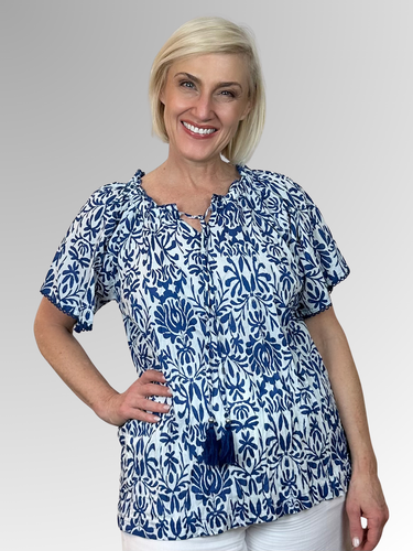 Beat the heat in style with the gorgeous Buzios Tassel Top from Orientique! Made from soft organic cotton, this charming piece features a soft ruffled neckline, tasseled strings and short sleeves that frame the shoulders perfectly. It's the ultimate combo of comfort and fashion that'll keep you looking fabulous and feeling cool all summer long.