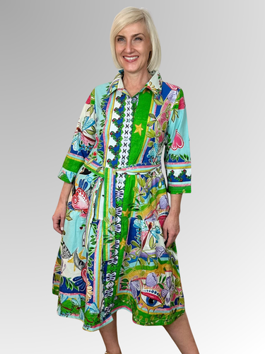 The Sante Fe Collared Tie Dress is your summer staple. This stylish knee-length dress features a classic collar, button-through front, and a tie waist belt that flatters your figure. Made from 100% organic cotton with 3/4 length sleeves, it's perfect for casual outings or special occasions.