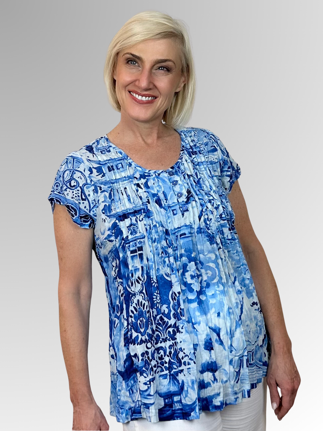 Beat the heat in style with the gorgeous Okayama Pleat Top from Orientique! Made from soft organic cotton, this charming piece features a buttoned V-neckline, pleating across the bust and back, and cap sleeves that frame the shoulders perfectly. It's the ultimate combo of comfort and fashion that'll keep you looking fabulous all summer long.