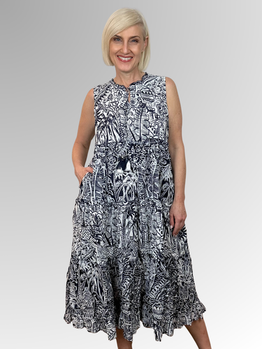 The Aksharay Navy Sleeveless Tassel Dress is your ticket to carefree summer fun. This lightweight midi features a relaxed silhouette, tasseled ties, a finely ruffled hem and a sleeveless design that keeps you cool and comfy all day long. Made from 100% organic cotton, it's the perfect companion for beach getaways, seaside strolls, and those golden-hour moments. Slip it on and embrace effortless style with a playful twist.