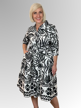 The Suriname Collared Tie Dress is your summer staple. This stylish knee-length dress features a classic collar, button-through front, and a tie waist belt that flatters your figure. Made from 100% organic cotton with 3/4 length sleeves, it's perfect for casual outings or special occasions.